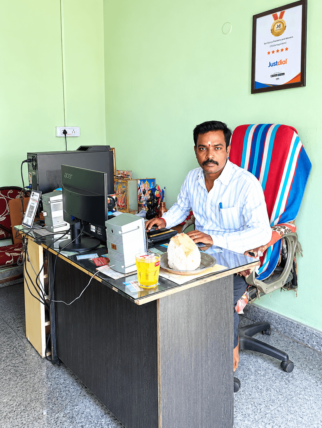 Owner of Sai Surya Packers and Movers in his office